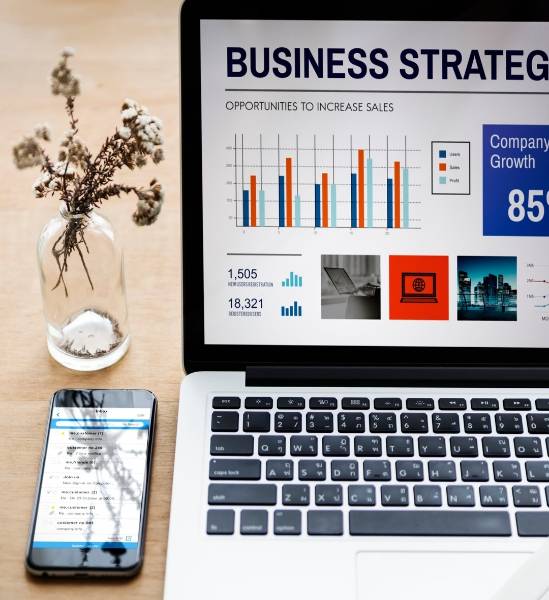 visionary news innovator, enthusiastic, planning new digital strategies, photorealistic, modern office with touch screens and charts, highly detailed, quick typing heard, 50mm lens, sleek modern tones, bright white lighting, shot with a 24-105mm camera lens.